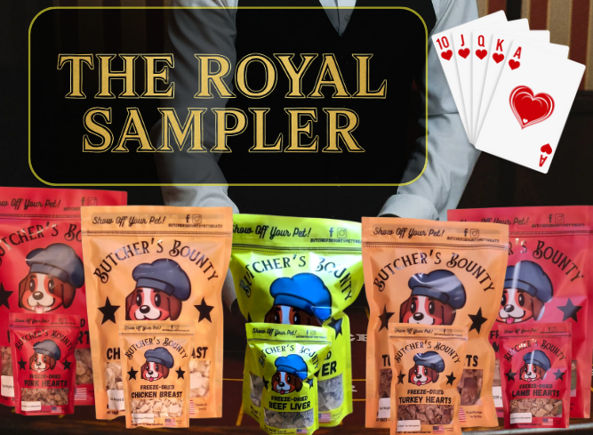 Five 2-oz Butcher’s Bounty freeze-dried treat bags—Beef Liver, Chicken Breast, Turkey Heart, Pork Heart, and Lamb Heart—fanned out beneath gold text reading ‘THE ROYAL SAMPLER’ on a dark green velvet backdrop